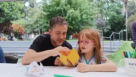Pai e filha dobrando origami juntos no Sesc Ipiranga
